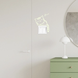 Detailed view of glow in the dark cat wall sticker on a home light switch panel