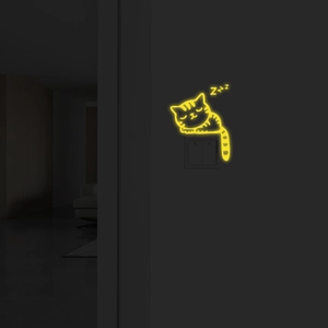 Luminous sleeping cat wall sticker with glowing Zzz icons above a light switch