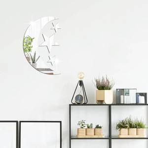 Detail view of mirror acrylic wall stickers with star and moon set on white bedroom wall