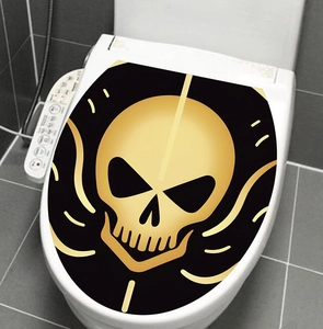 Detail of Halloween black and gold skull decal on a modern white toilet lid cover