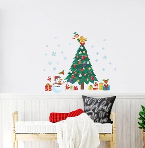 Detail of Christmas tree and snowman wall stickers on a white wall in a cozy room