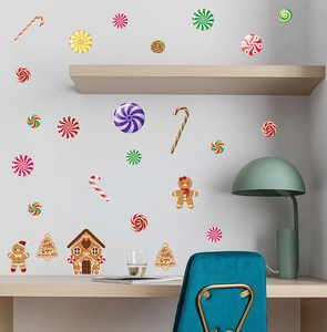 Close-up of colorful Christmas gingerbread man and candy cane wall decals in home office