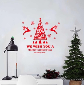 Close-up of red Christmas tree and reindeer wall decals in a cozy home office setting