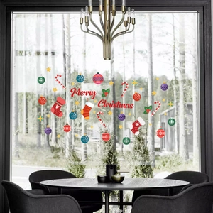 Festive Merry Christmas window stickers featuring ornaments and stockings on a glass door