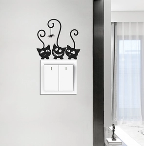 Detail of creative cartoon black cat wall stickers decorating a dual light switch panel