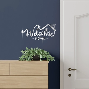 Detail of silver mirror acrylic Welcome Home wall sticker on a dark blue interior wall