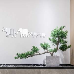 Detail view of 3D acrylic mirror elephant family wall stickers on minimalist white wall