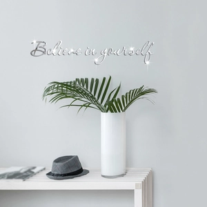 Macro detail of silver acrylic mirror wall decal featuring Believe in yourself text
