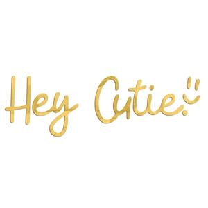 Macro shot of gold acrylic mirror wall decal featuring Hey Cutie script and a smiley face