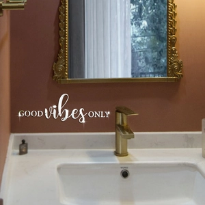 Close-up of silver mirror acrylic wall sticker featuring Good Vibes Only quote
