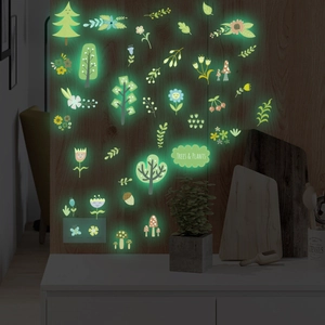 Luminous wall stickers set showing trees and mushrooms glowing green in the dark room