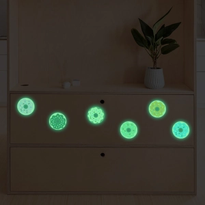 Luminous donut wall stickers set of six glowing in the dark on a wooden cabinet surface