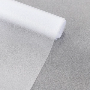 Macro detail of white frosted privacy window film with matte texture and light diffusion
