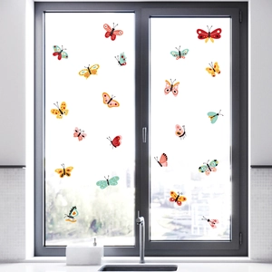 Colorful decorative butterfly wall stickers for home decor on a bright window glass