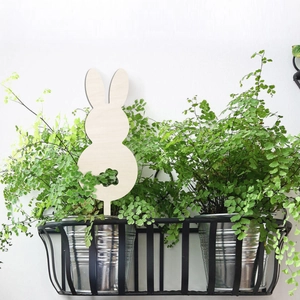 Garden rabbit wooden plant stake with clover cutout decoration in outdoor flower pot