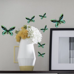 Vibrant green luminous butterfly wall stickers arranged on a wall with home decor