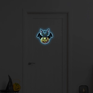 Luminous Halloween bat and pumpkin wall sticker glowing in a dark room setting