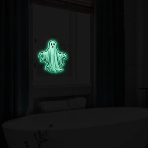 Glow in the dark ghost wall decal in a dark bathroom for Halloween party decorations