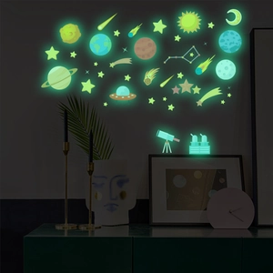 Glow in the dark space themed wall stickers showing luminous planets and stars in a bedroom