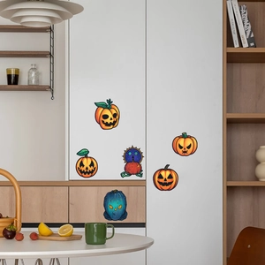 Detail of Halloween pumpkin decals with different expressions on a white cabinet