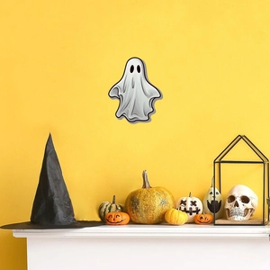 Luminous Halloween ghost wall sticker displayed above a festive mantel with pumpkins