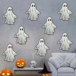 Luminous Halloween ghost wall stickers displayed on grey wall with festive decor