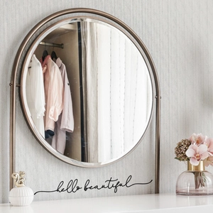 Minimalist round gold metal frame vanity mirror with Hello Beautiful text decal