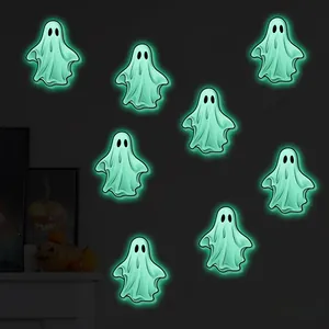 Detail of eight luminous ghost wall stickers showing green glowing effect in the dark
