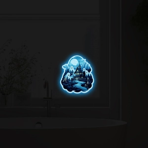 Glow-in-the-dark Halloween wall sticker showing bright blue ghosts and haunted house in moonlight
