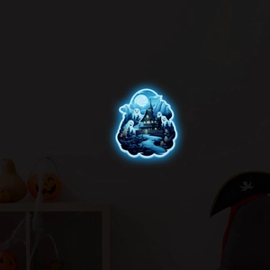 Close-up of glowing blue Halloween ghost wall light with haunted castle and forest motif