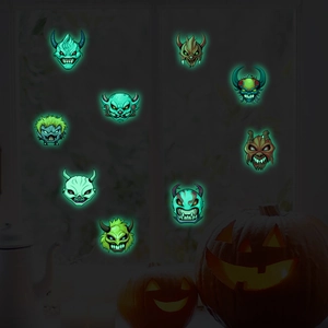 Luminous Halloween cartoon monster masks glowing in the dark with a pumpkin lantern backdrop