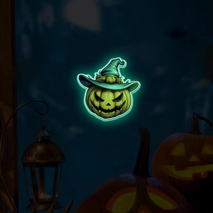 Macro shot of glow-in-the-dark Halloween pumpkin sticker with witch hat in dark setting