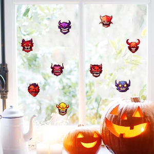 Halloween monster window stickers displayed on glass with pumpkins for festive decor