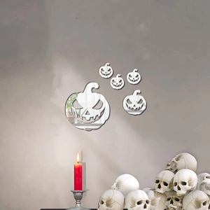 Set of 5 acrylic pumpkin mirror wall stickers displayed with spooky candles and skull decor