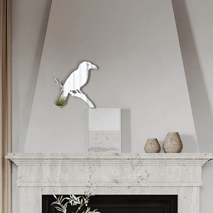 Macro detail of silver acrylic bird on branch 3D mirror wall sticker for home decoration