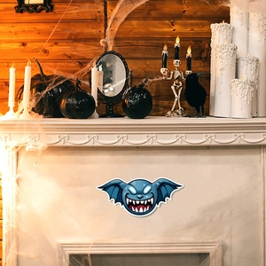 Blue bat monster glowing sticker on fireplace with Halloween pumpkins and spider web