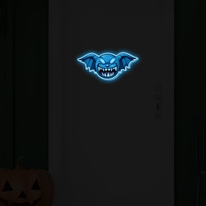 Blue neon bat wall sticker glowing on a dark door for Halloween party decoration