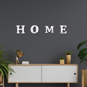 Detail of HOME acrylic mirror wall stickers on a dark gray minimalist textured living room wall