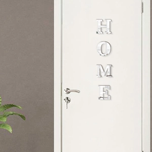 Close-up of silver acrylic HOME mirror wall stickers on a white interior door