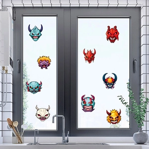 Close-up of colorful monster stickers applied on a glass window for Halloween decoration