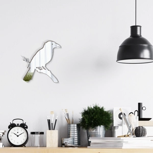 Macro view of acrylic mirror wall sticker featuring a raven on a branch for home decor