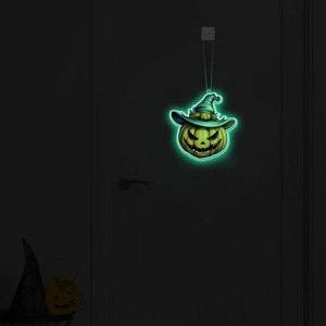 Luminous Halloween pumpkin pendant with wizard hat glowing in dark on door