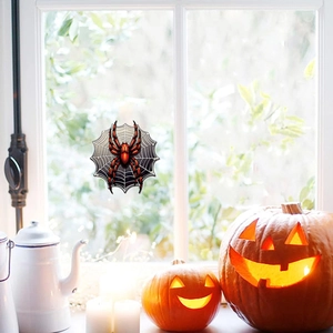 Detailed view of Halloween spider and web glow stickers on glass window for decoration