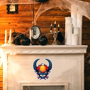 Luminous Halloween devil sticker on a white fireplace with spooky festive decor accessories