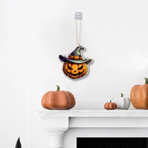 Detail of Halloween pumpkin hanging decoration with wizard hat on a white festive wall