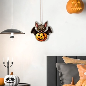 Close-up of a cartoon bat in a pumpkin wooden pendant for Halloween home decoration