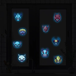 Luminous Halloween stickers featuring nine cartoon ghost designs glowing on window glass