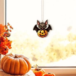 Close-up of a cartoon bat holding a pumpkin hanging decoration for Halloween party decor