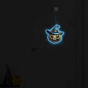 Luminous Halloween pumpkin pendant with blue witch hat glowing on a dark door