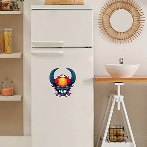 Close-up of a luminous cartoon monster decal on a white refrigerator for Halloween